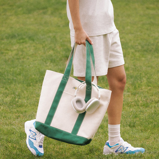 AROSRIS Canvas Tennis Tote in Varsity Green — street style shot showing structured silhouette and dual handle carry