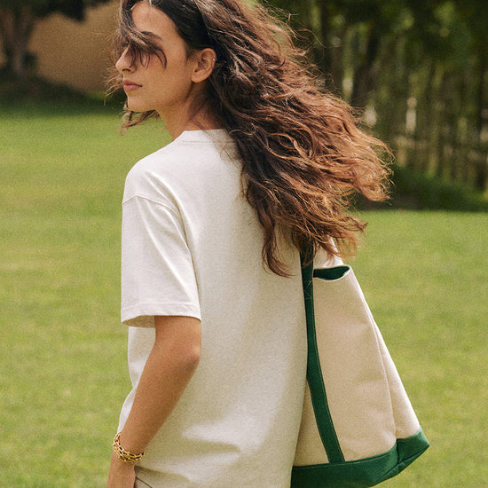AROSRIS Structured Tennis Tote in Varsity Green — outdoor lifestyle shot showing bag size and sporty Old Money aesthetic