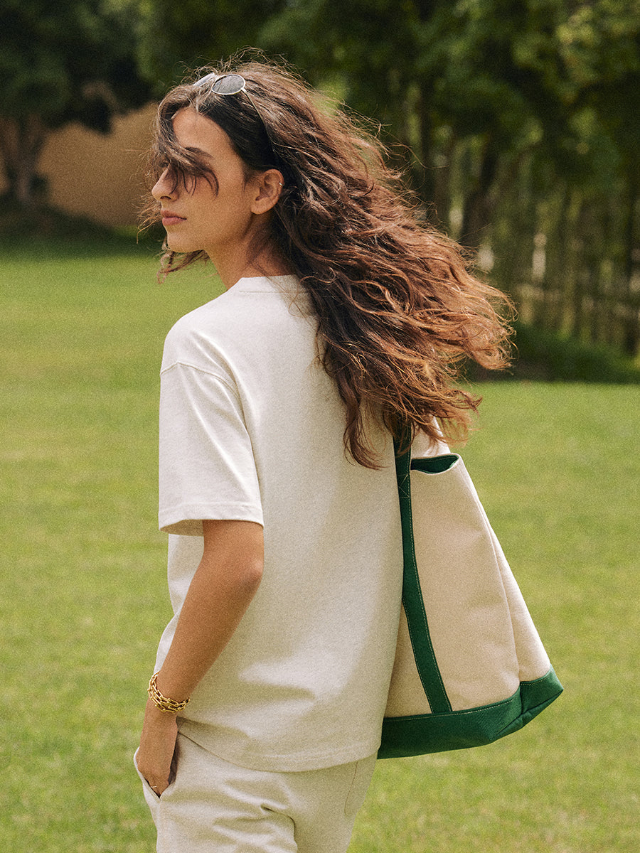 AROSRIS Structured Tennis Tote in Varsity Green — outdoor lifestyle shot showing bag size and sporty Old Money aesthetic