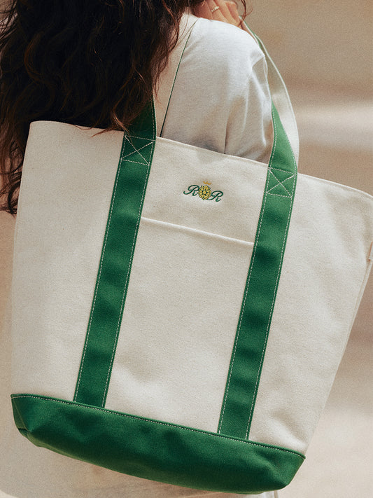 AROSRIS Structured Canvas Tennis Tote in Varsity Green — close-up showing PVC-reinforced structure, crest embroidery and zip-top closure