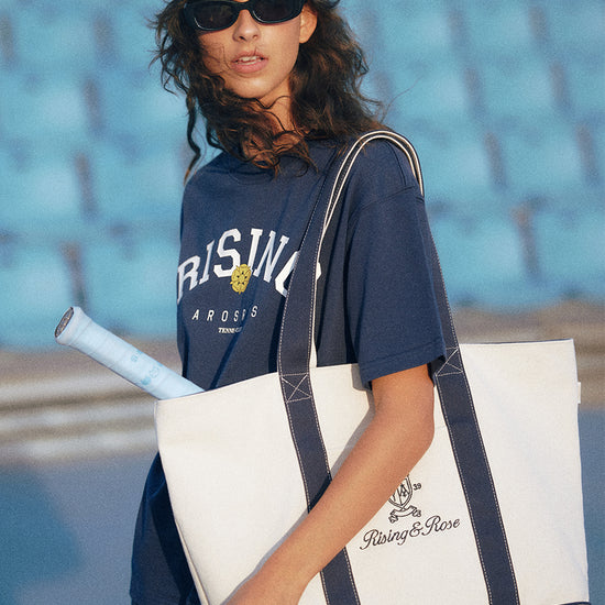 AROSRIS Heritage Embroidered Canvas Tote — street style shot showing oversized structured silhouette and heritage embroidery detail