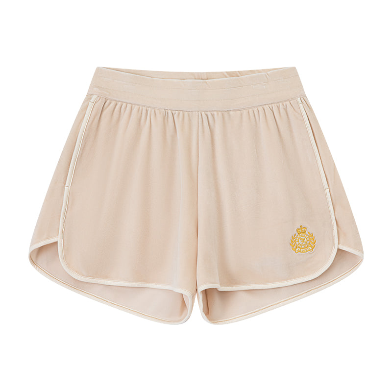 AROSRIS Holiday Velvet Shorts in cream — flat lay showing soft velour fabric, rolled hem detail and badge embroidery