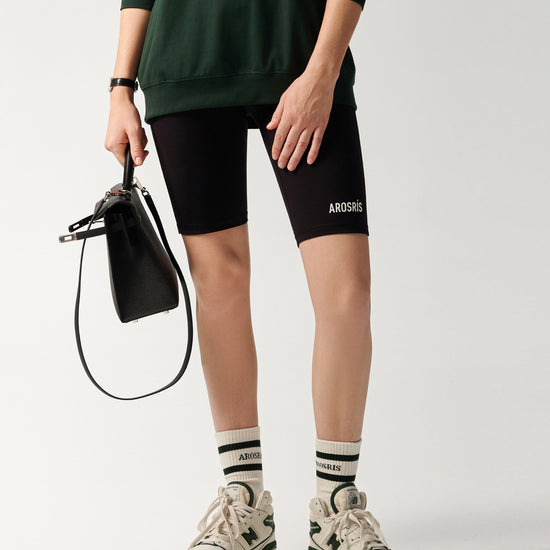 AROSRIS Naked Feel Compression Shorts in Midnight Black — active lifestyle shot showing 4-way stretch and body-sculpting fit