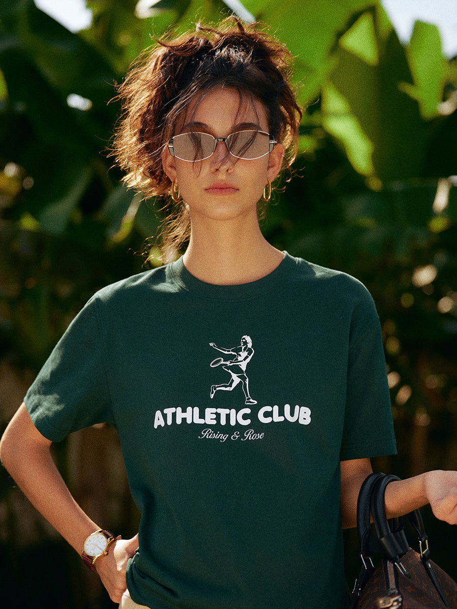AROSRIS Kay Stammers Tribute Tee — side profile showing drop-shoulder cut and Varsity Green vintage hue in natural light