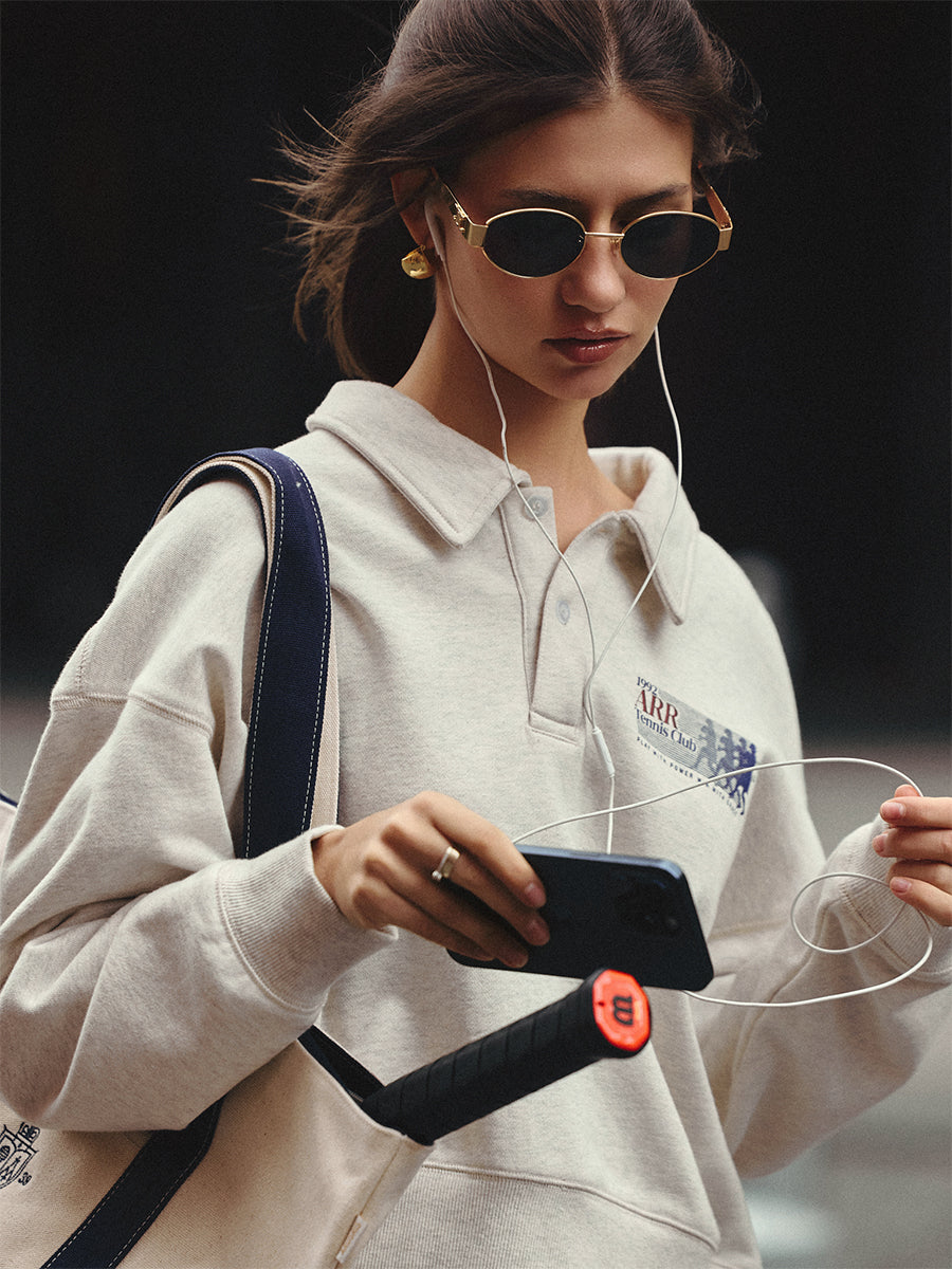 AROSRIS Tennis Club Retro Cotton Polo Sweatshirt in Oatmeal Heather — close-up showing polo collar detail and vintage collegiate graphic