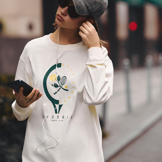 AROSRIS Tennis Club Pima Cotton Long Sleeve Tee in Vintage Apricot — full body street style showing relaxed silhouette and retro tennis graphic