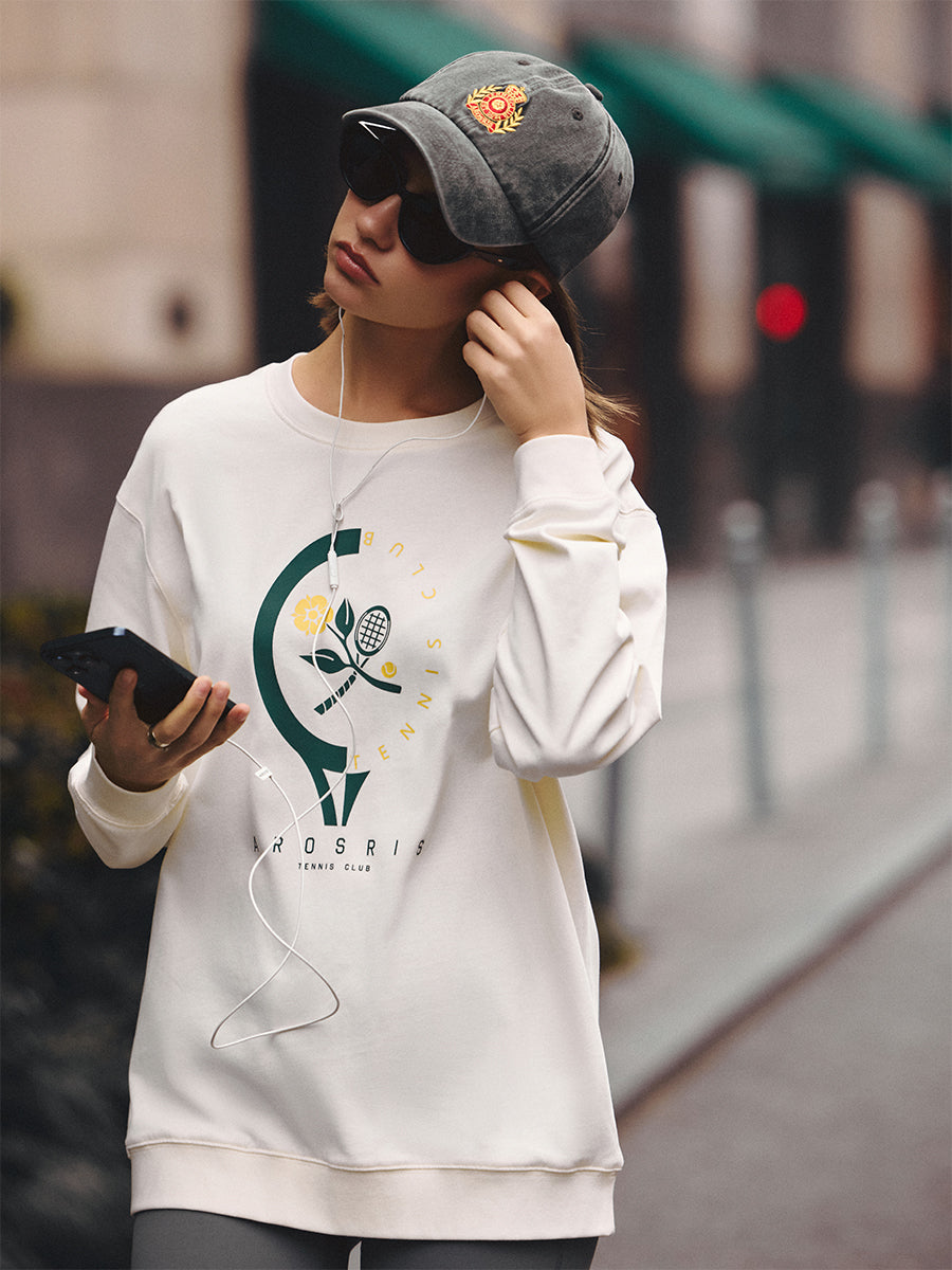 AROSRIS Tennis Club Pima Cotton Long Sleeve Tee in Vintage Apricot — full body street style showing relaxed silhouette and retro tennis graphic