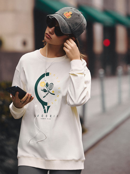AROSRIS Tennis Club Pima Cotton Long Sleeve Tee in Vintage Apricot — full body street style showing relaxed silhouette and retro tennis graphic
