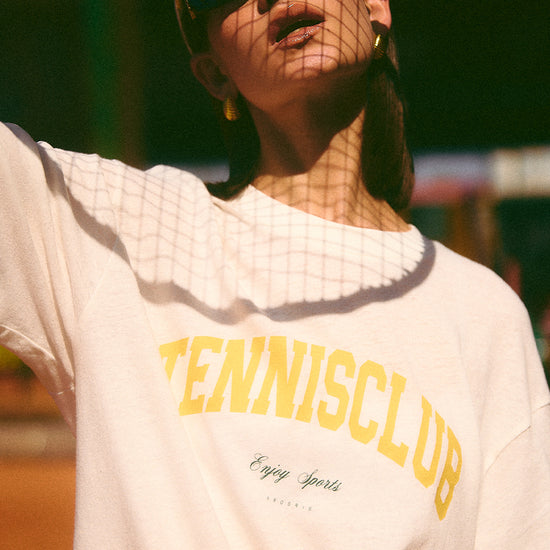 AROSRIS Tennis Club Sheer Texture Graphic Tee in Midsummer White — close-up showing vintage collegiate lettering and snowflake cotton texture