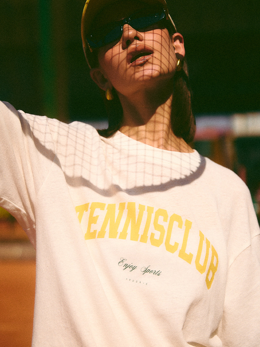 AROSRIS Tennis Club Sheer Texture Graphic Tee in Midsummer White — close-up showing vintage collegiate lettering and snowflake cotton texture