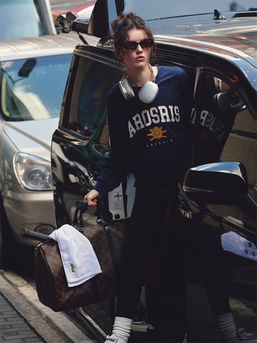 AROSRIS The Princess Retro Crest Pullover — full body street style showing oversized silhouette and vintage varsity crest graphic