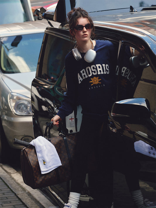 AROSRIS The Princess Retro Crest Pullover — full body street style showing oversized silhouette and vintage varsity crest graphic