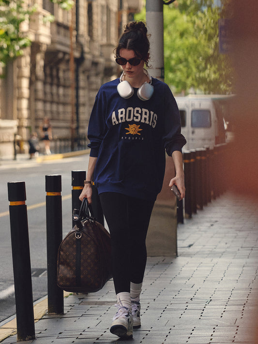 AROSRIS The Princess Retro Pullover in Royal Navy — outdoor street style showing relaxed bum-covering length and crest print