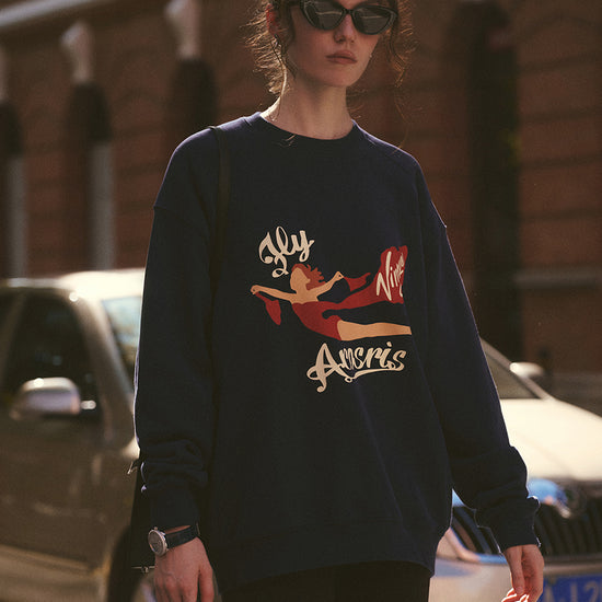 AROSRIS The Princess Graphic Sweatshirt in Royal Navy — outdoor lifestyle shot showing brushed terry fabric and crewneck silhouette