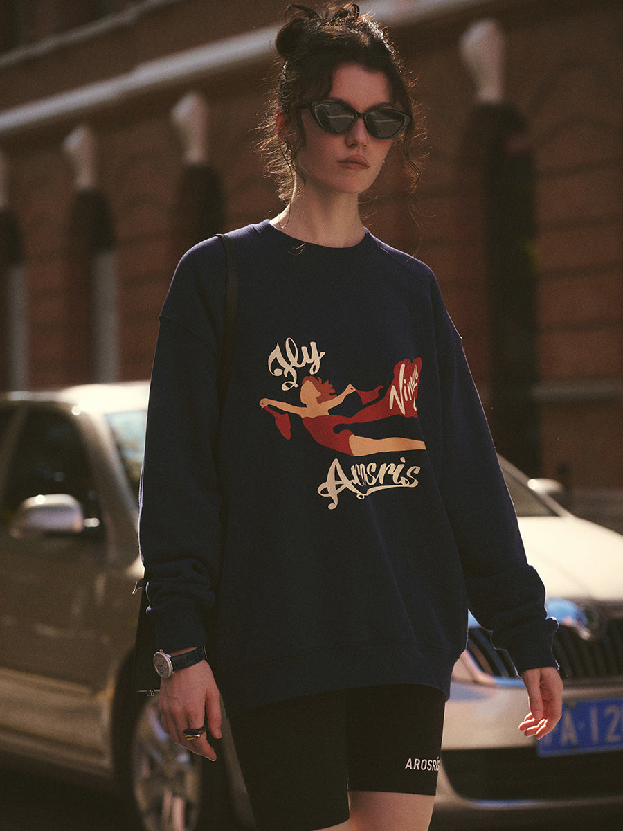 AROSRIS The Princess Graphic Sweatshirt in Royal Navy — outdoor lifestyle shot showing brushed terry fabric and crewneck silhouette