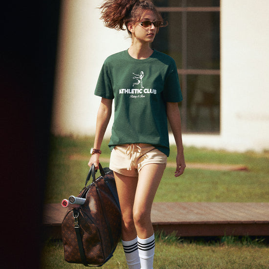 AROSRIS Vintage Tennis Graphic Tee in Varsity Green — full body street style showing relaxed drop-shoulder fit and rich vintage colorway