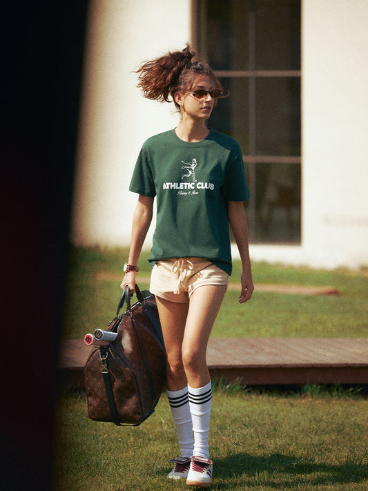 AROSRIS Vintage Tennis Graphic Tee in Varsity Green — full body street style showing relaxed drop-shoulder fit and rich vintage colorway