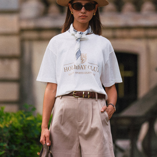 AROSRIS Princess Pleated Shorts in Beige — front view showing high-waist double pleat detail and fluid suiting drape