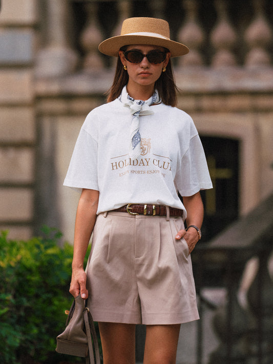 AROSRIS Princess Pleated Shorts in Beige — front view showing high-waist double pleat detail and fluid suiting drape