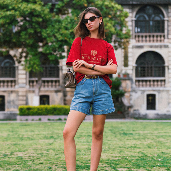 AROSRIS Princess A-Line Denim Shorts in Vintage Washed Blue — outdoor lifestyle shot showing vintage wash finish and flattering silhouette in motion