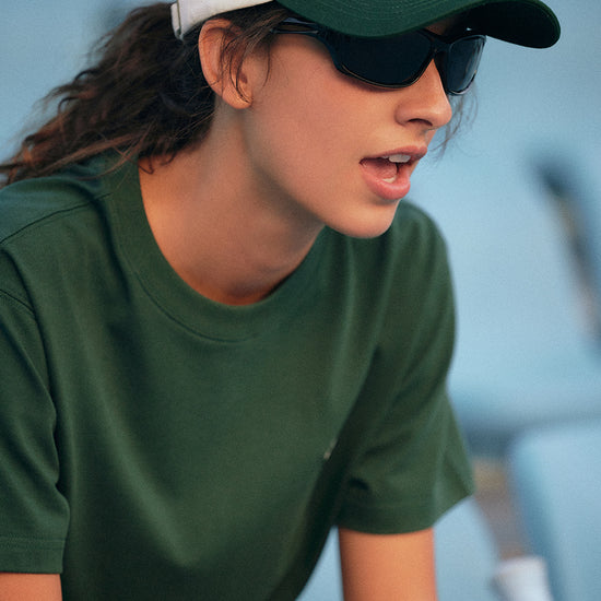 AROSRIS Vintage Embroidered Dad Hat styled with matching green athletic set — showing off-duty sporty aesthetic