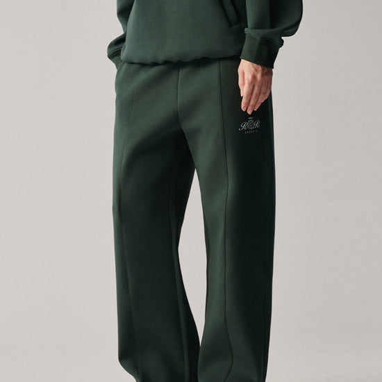 Close-up of AROSRIS City Concerto Pants in dark green — center pintuck seam detail and clean tailored finish