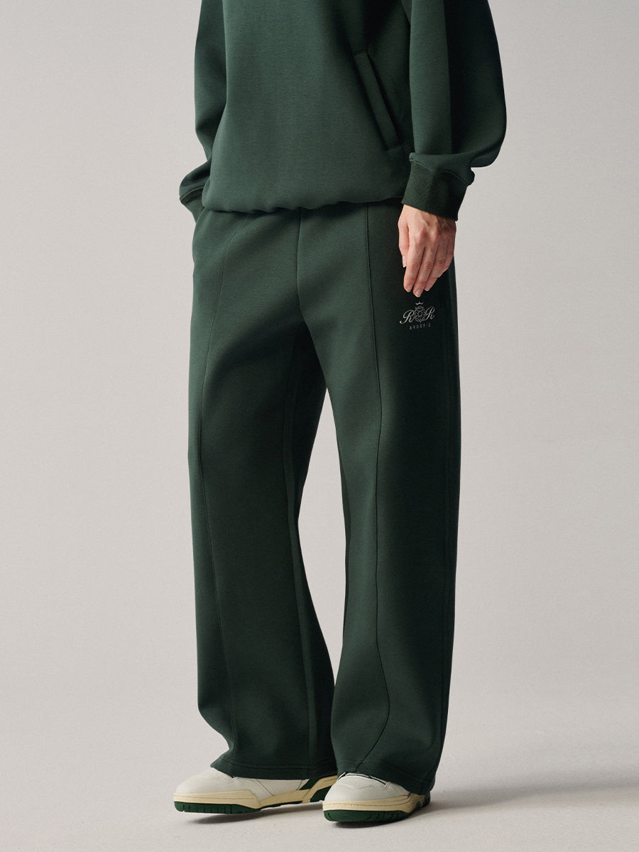 Close-up of AROSRIS City Concerto Pants in dark green — center pintuck seam detail and clean tailored finish