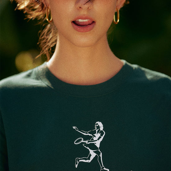 AROSRIS Kay Stammers Tribute Vintage Tennis Graphic Tee in Varsity Green — close-up showing Athletic Club tribute graphic and drop-shoulder silhouette