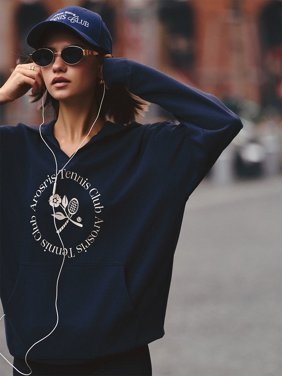 AROSRIS Tennis Club Vintage V-Neck Hoodie in Misty Navy — street style shot showing V-neck design and heritage graphic print