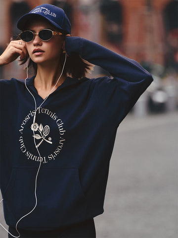 AROSRIS Tennis Club Vintage V-Neck Hoodie in Misty Navy — street style shot showing V-neck design and heritage graphic print