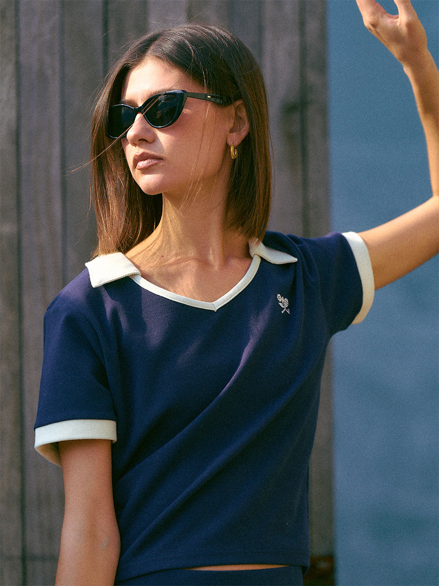 AROSRIS Tennis Club Contrast Polo in Quiet Navy — outdoor shot showing V-neckline and 3D waffle knit texture