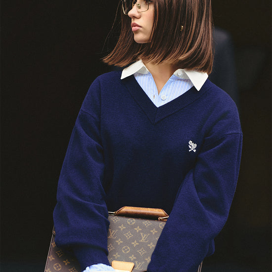 AROSRIS Old Money 100% Merino Wool V-Neck Sweater in Quiet Navy — close-up showing V-neck collar and small flower embroidery detail