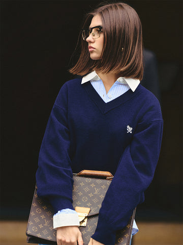 AROSRIS Old Money 100% Merino Wool V-Neck Sweater in Quiet Navy — close-up showing V-neck collar and small flower embroidery detail