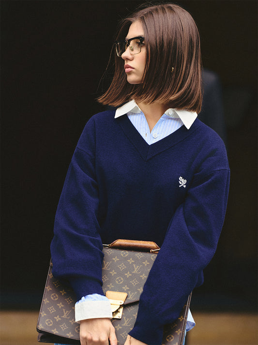 AROSRIS Old Money 100% Merino Wool V-Neck Sweater in Quiet Navy — close-up showing V-neck collar and small flower embroidery detail
