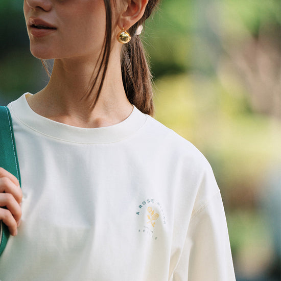 Close-up of AROSRIS Tennis Friendship graphic tee in white — vintage tennis print detail