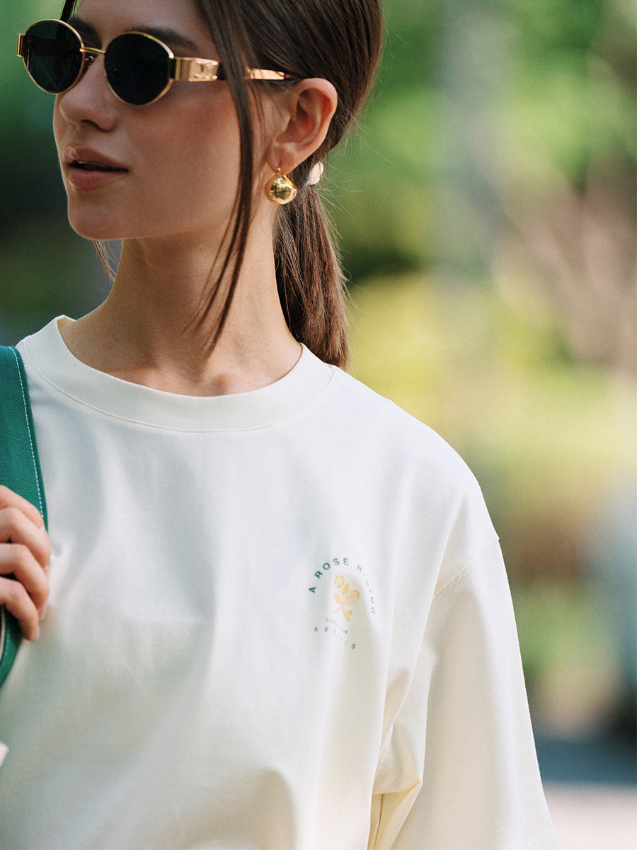 Close-up of AROSRIS Tennis Friendship graphic tee in white — vintage tennis print detail