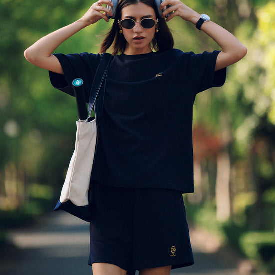 AROSRIS City Stroll Shorts in navy — outdoor lifestyle shot styled with matching waffle tee