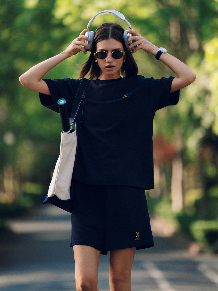 AROSRIS City Stroll Shorts in navy — outdoor lifestyle shot styled with matching waffle tee