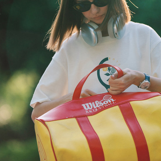 AROSRIS Morning Run Graphic Tee in white — outdoor shot showing retro tennis racket chest print and waffle texture