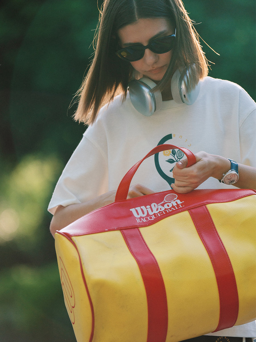 AROSRIS Morning Run Graphic Tee in white — outdoor shot showing retro tennis racket chest print and waffle texture