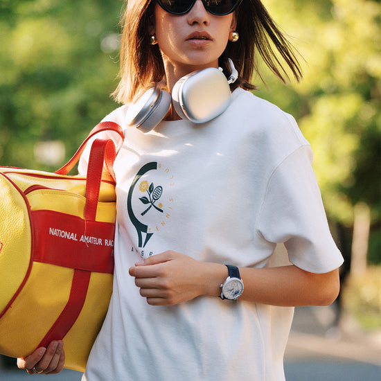 Close-up of AROSRIS Morning Run Waffle Tee in white — retro Tennis Series graphic print detail on chest