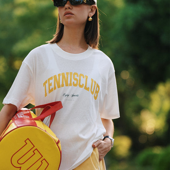 AROSRIS Tennis Club Sheer Tee styled with shorts — showing relaxed silhouette and vintage tennis graphic in natural light