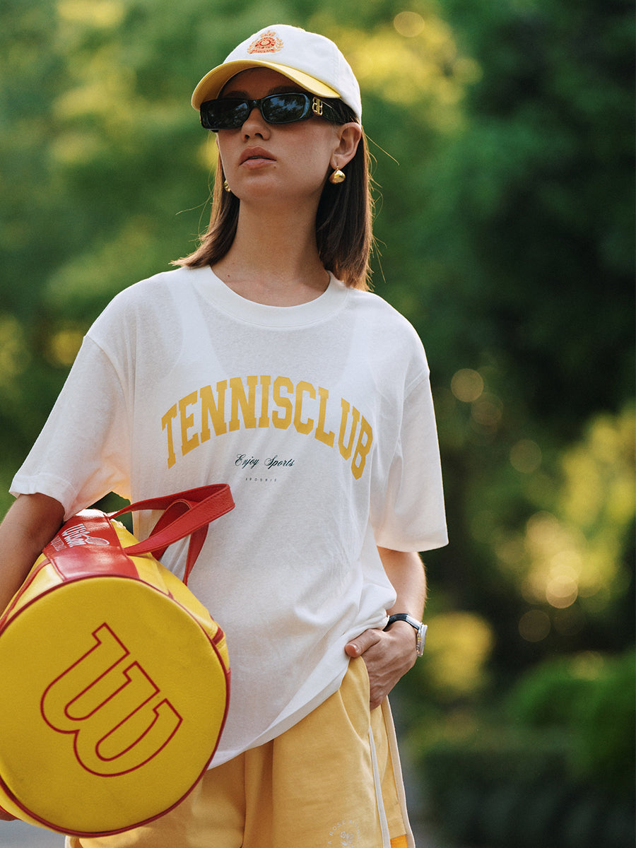 AROSRIS Tennis Club Sheer Tee styled with shorts — showing relaxed silhouette and vintage tennis graphic in natural light