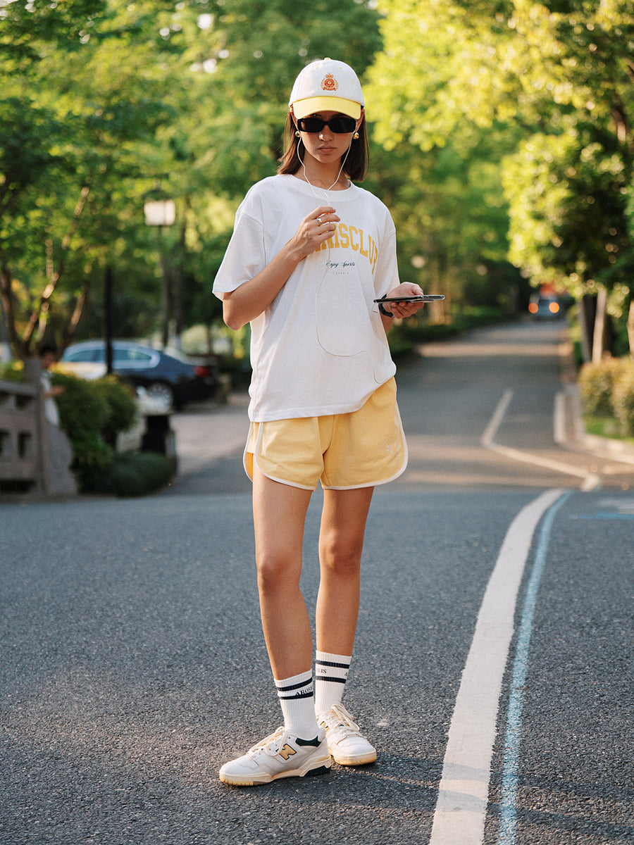 AROSRIS Avenue Cotton Shorts in forest green — outdoor lifestyle shot showing relaxed A-line fit