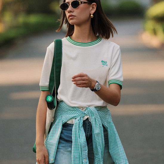 AROSRIS Morning Walk Ringer Tee in court green — outdoor lifestyle shot showing terry cloth texture and classic ringer design