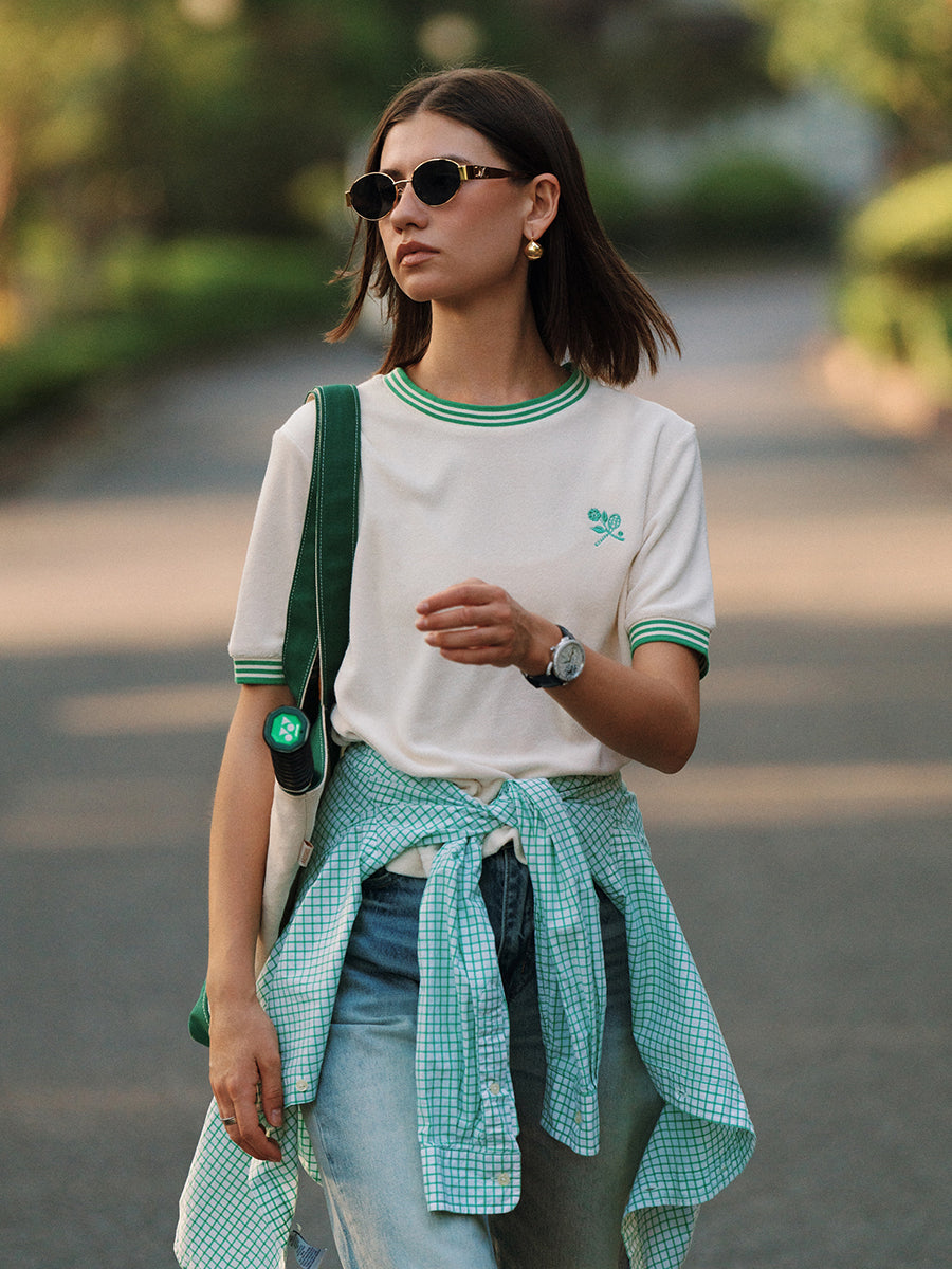 AROSRIS Morning Walk Ringer Tee in court green — outdoor lifestyle shot showing terry cloth texture and classic ringer design