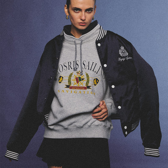 Arosris ash grey sailing navigation mock neck sweatshirt elegantly styled on a model, capturing an effortless 90s sporty-chic coastal yacht club aesthetic.