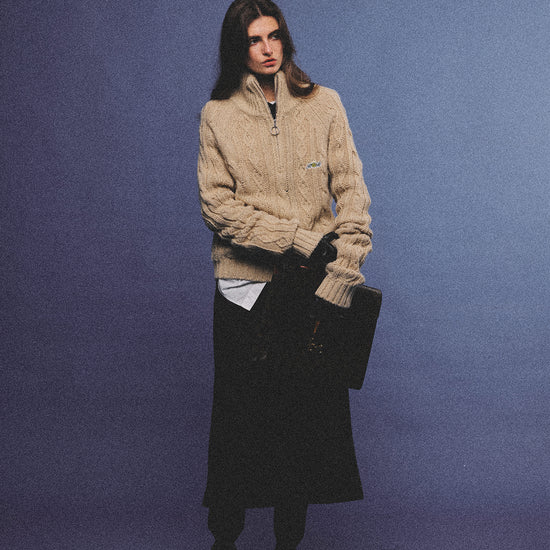 Arosris oatmeal latte cable knit half-zip sweater elegantly styled on a model over a crisp white collared shirt, capturing an effortless 90s preppy and old money academia aesthetic.