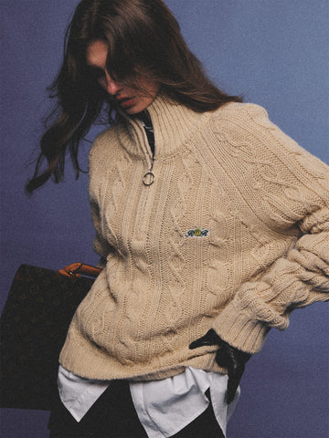 Arosris oatmeal latte cable knit half-zip sweater elegantly styled on a model over a crisp white collared shirt, capturing an effortless 90s preppy and old money academia aesthetic.