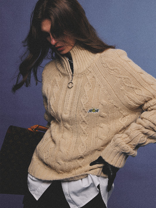 Arosris oatmeal latte cable knit half-zip sweater elegantly styled on a model over a crisp white collared shirt, capturing an effortless 90s preppy and old money academia aesthetic.
